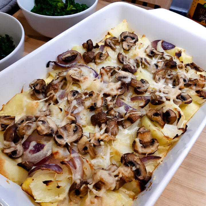 Baked potatoes with mushrooms in a roasting dish