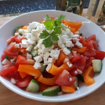 Shopska salad served with feta cheese and parsley