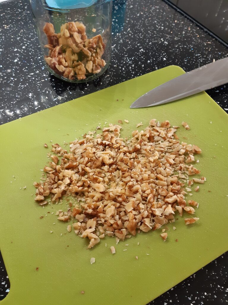 chopped walnuts on a chopping board