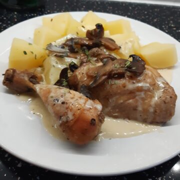 roast chicken parts served with creamy sauce and mushrooms
