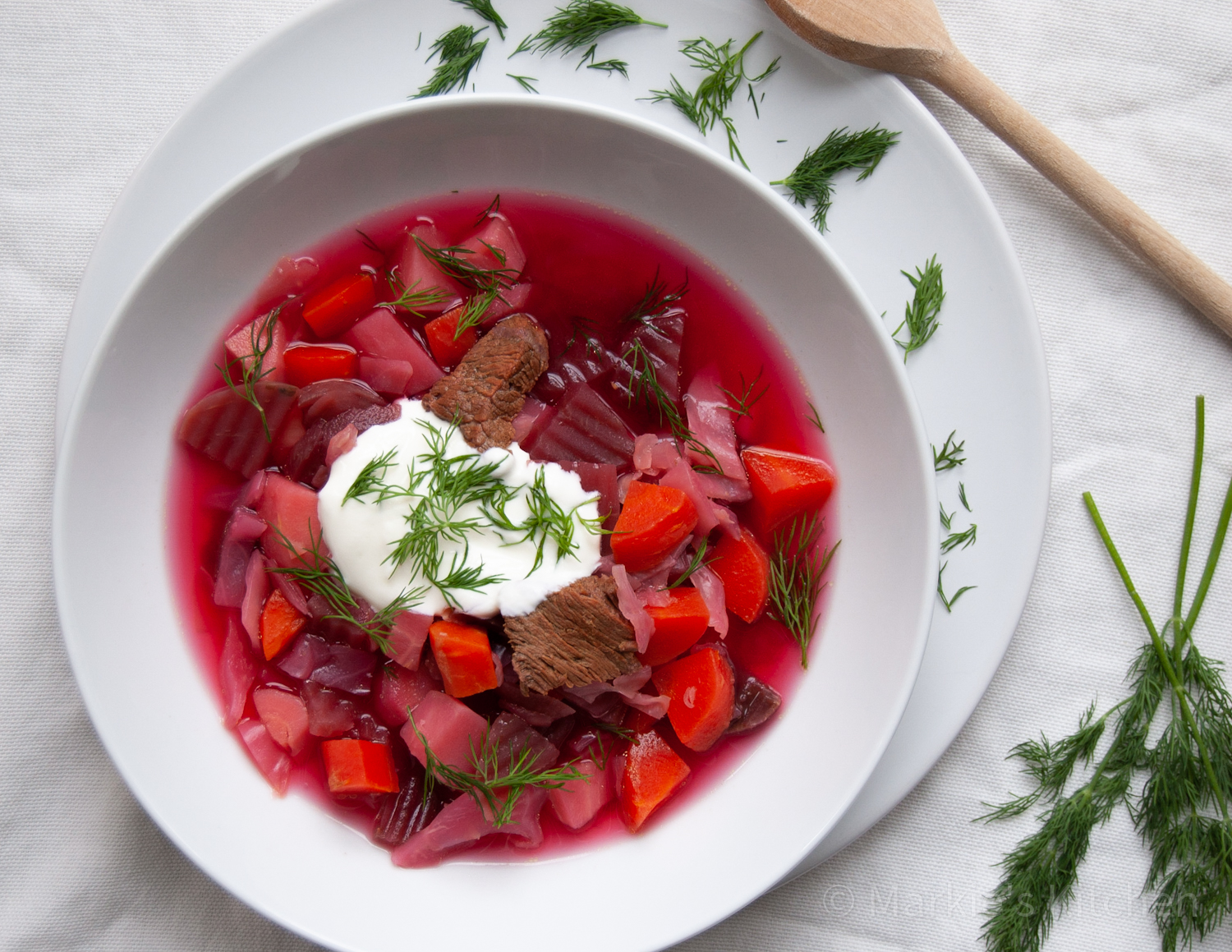 Beetroot soup served with soured cream and fresh dill
