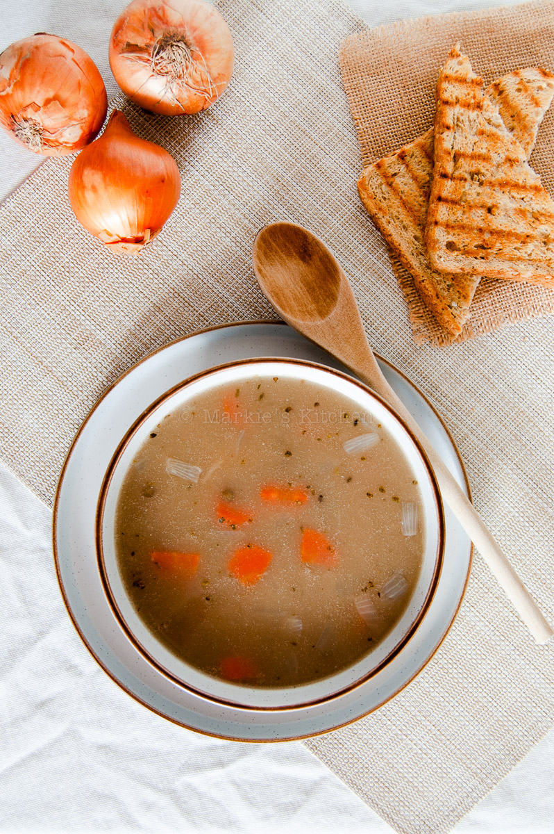 Lentil soup in a bowl. Served with a slice of bread.