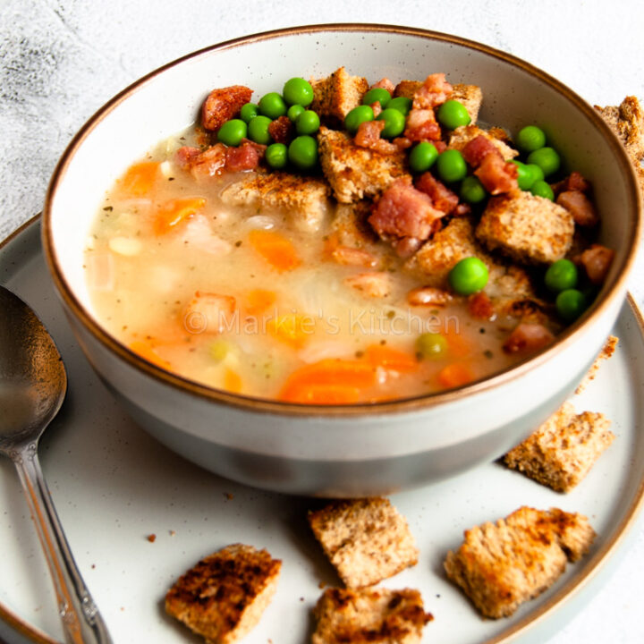 yellow pea soup served in a bowl with bread croutons and pancetta