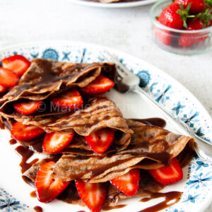 triple chocolate crepe with chocolate sauce and strawberry