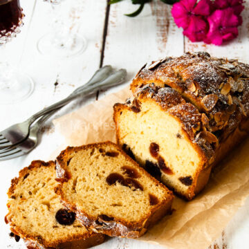 a close up photo of cherry madeira cake with almonds