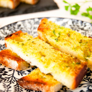 A photo of slices of homemade garlic bread.