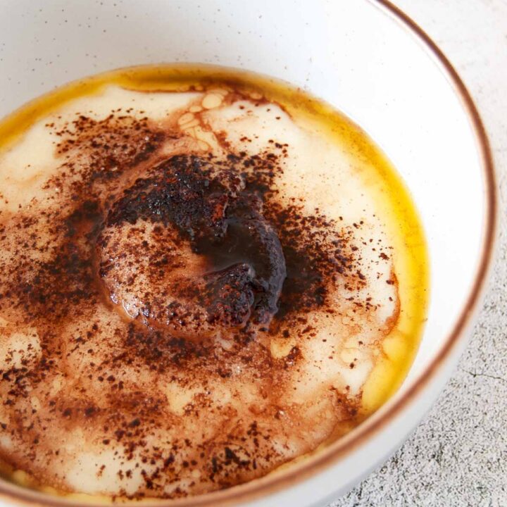 A photo of a bowl of semolina porridge with cocoa powder and melted butter.